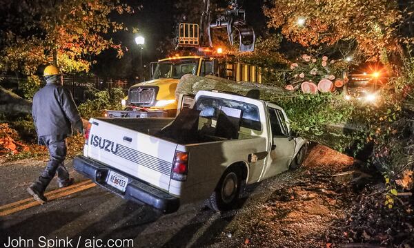 A truck driver was slightly injured when a tree fell on his truck Thursday on Sells Avenue and Lawton Street in Atlanta. JOHN SPINK / JSPINK@AJC.COM