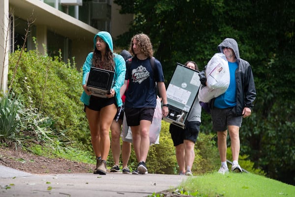 A group of students and parents walks to the entrance of Boggs Hall with dorm furnishings on Monday, Aug. 16, 2021 on the University of Georgia's Campus in Athens, Georgia. Move in commenced on Friday, Aug. 13 ahead of the start of classes on Wednesday, Aug. 18. (Julian Alexander for the Atlanta Journal-Constitution)