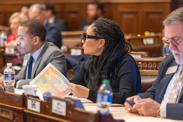 State House Rep. Inga Willis, D-Atlanta, reviews a map during discussion of redistricting bill SB 3EX during the special legislative session at the Capitol in Atlanta on Thursday, December 7, 2023. (Arvin Temkar / arvin.temkar@ajc.com)