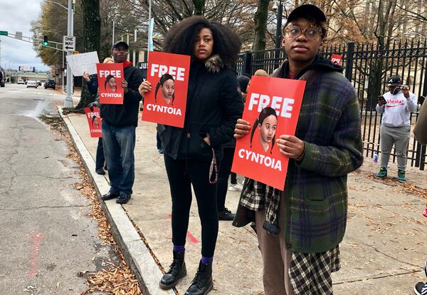 Spelman College student Eva Dickerson (right) and Atlanta resident Jill Cartwright (center) hold signs in support of a clemency push for Tennessee inmate Cyntoia Brown outside the Georgia Capitol in 2018, in downtown Atlanta. Legal activists are urging Tennessee Gov. Bill Haslam to grant Brown’s clemency petition in a case that’s gained international attention. J. SCOTT TRUBEY/STRUBEY@AJC.COM