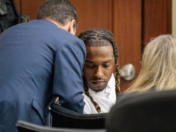 Joshua Moore, an attorney with the Georgia capital defender office, speaks with his client Bryan Rhoden.