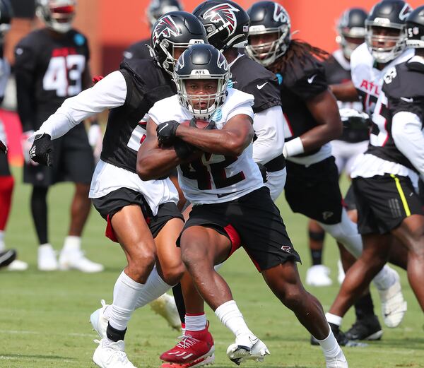 Falcons rookie running back Caleb Huntley finds some running room during the fourth day of training camp practice Sunday, Aug. 1, 2021, in Flowery Branch. (Curtis Compton / Curtis.Compton@ajc.com)