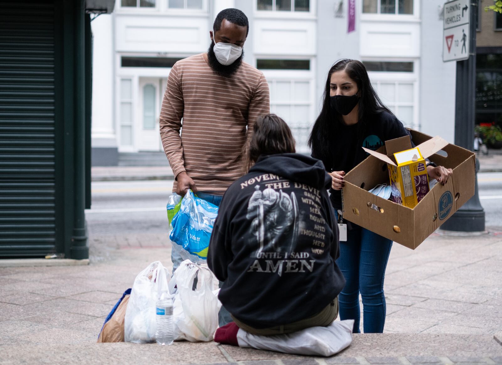 Brandon Russ, left, and Donia Hanaei talk about PAD's services downtown. Ben Gray for the Atlanta Journal-Constitution