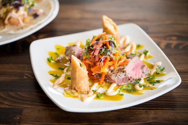 Rise & Revelry Ahi Tuna with vegetable egg rolls and ginger vinaigrette with habanero aioli.