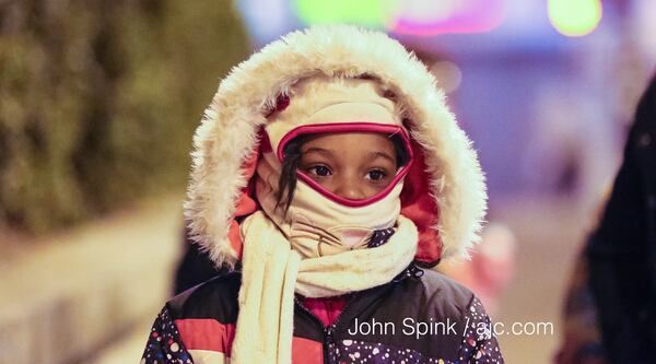 Shamiya Smith, 6, is bundled up for her walk to school Friday on Wall Street in Atlanta.