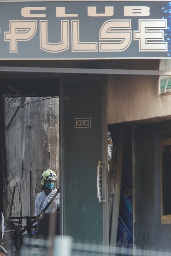 A firefighter inspects a nightclub after a massive fire in the town of Kocani, North Macedonia, Sunday, March 16, 2025. (AP Photo/Boris Grdanoski)