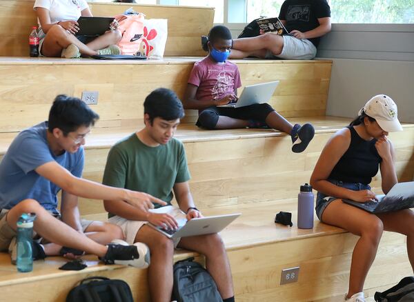 Georgia Tech student Caleb Anderson (center) studies in the lobby area of the G. Wayne Clough Undergraduate Learning Commons with other students following a chemistry lab at Georgia Tech on Wednesday, August 25, 2021. (Curtis Compton / Curtis.Compton@ajc.com)