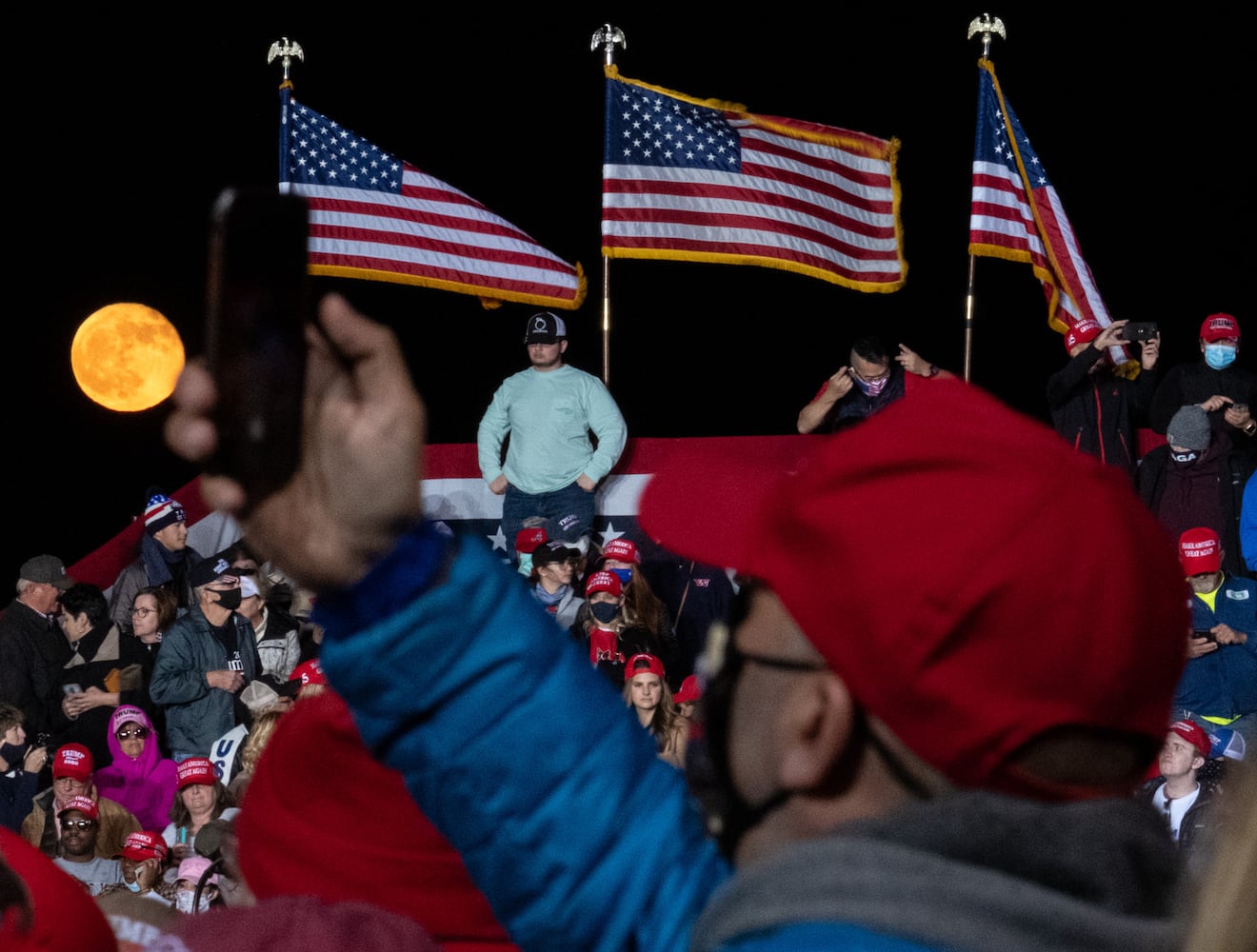 The moon rises behind supporters before the beginning of a Trump rally at Richard B. Russell Airport in Rome on Sunday evening, Nov. 1, 2020. (Photo: Ben Gray for The Atlanta Journal-Constitution)