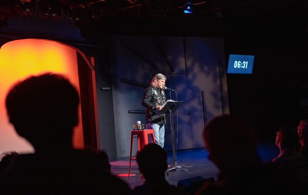 Jeremy Maxwell tells his story on the subject of Rebirth at Write Club, a monthly storytelling competition held at Dad's Garage on Wednesday, April 10, 2024.  Contestants, known as Combatants, are given a theme and seven minutes to present, after which the crowd votes with applause. Jenni Girtman for The Atlanta Journal-Constitution)