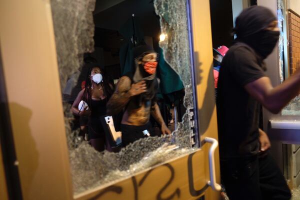 Windows of downtown businesses were shattered as an earlier peaceful rally in downtown Atlanta turned violent later in the evening on Friday, May 29, 2020. (Photo: Ben Gray for The Atlanta Journal Constitution)