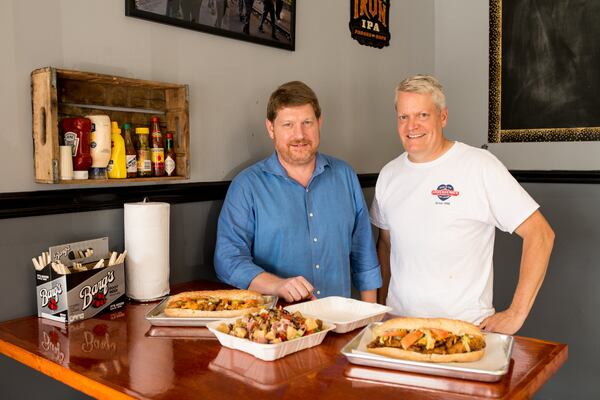 Mark Ferguson (left) and Dave Schmidt are co-owners of the Po’Boy Shop. CONTRIBUTED BY MIA YAKEL