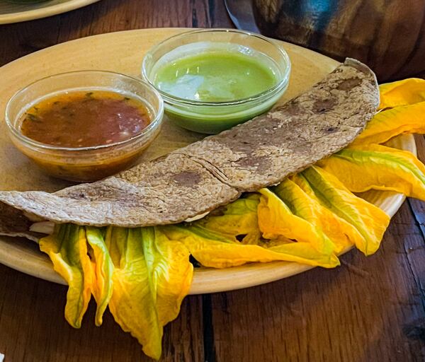 Oaxaca's flor de calabaza quesadilla is filled with mushrooms and squash blossoms arranged like rays of sunlight. Henri Hollis/henri.hollis@ajc.com