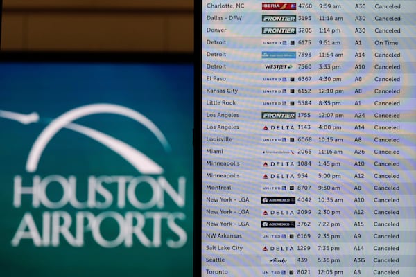 All cancelled flights are shown on the flight board at the closed George Bush Intercontinental Airport Tuesday, Jan. 21, 2025, in Houston. (AP Photo/David J. Phillip)