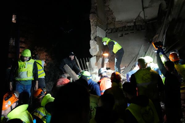 Rescue workers search for victims at the site of an Israeli airstrike in Beirut, Lebanon, Monday, Nov. 18, 2024. (AP Photo/Hussein Malla)