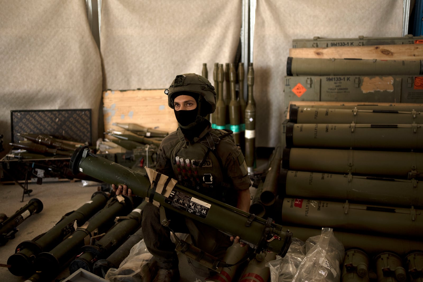 An Israeli soldier from an EOD (explosive ordnance disposal) poses with a weapon used by Hezbollah seized during combat operations in Lebanon displayed during a government-organized media tour on a base in southern Israel, Wednesday, Oct. 9, 2024. (AP Photo/Maya Alleruzzo)