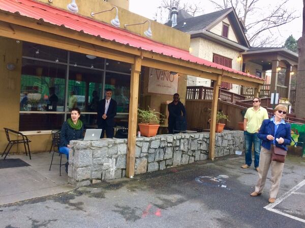 Poncey-Highland Neighborhood Association member Lisa Malaney and president Jerry Finegold hold a lightly attended, social distancing board meeting outside a coffee house. Photo by Bill Torpy