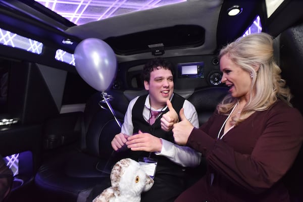 Jason Reynolds smiles as his date, Jennifer Hendricks, gives him a thumbs-up during a limousine ride as a part of the “Night to Shine” event on Feb. 8 at First Baptist Church Atlanta in Dunwoody. The event gives people with disabilities a chance to enjoy a prom night experience. HYOSUB SHIN / HSHIN@AJC.COM