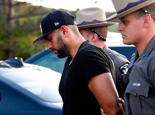 Nauman Hussain is brought into Cobleskill Town, N.Y., court for arraignment Wednesday, Oct. 10, 2018. Limousine service operator, Hussain, was charged Wednesday with criminally negligent homicide in a crash that killed 20 people, while police continued investigating what caused the wreck and whether anyone else will face charges. (AP Photo/Hans Pennink)