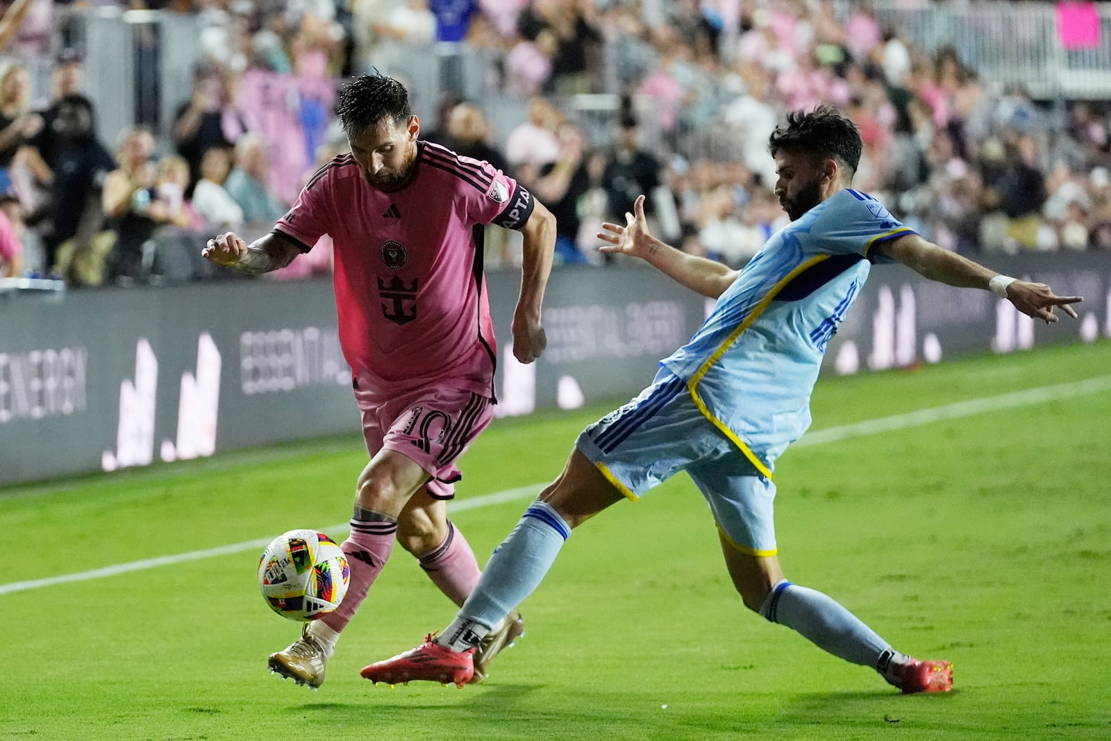 Atlanta United defender Pedro Amador (18) and Inter Miami forward Lionel Messi (10) go after the ball during the second half of their MLS playoff opening round soccer match, Friday, Oct. 25, 2024, in Fort Lauderdale, Fla. (AP Photo/Rebecca Blackwell)