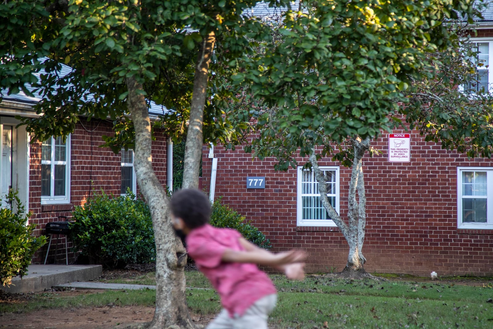 A child plays outside at Trestletree Village Apartments in Atlanta’s Grant Park neighborhood. (Alyssa Pointer/ AJC)