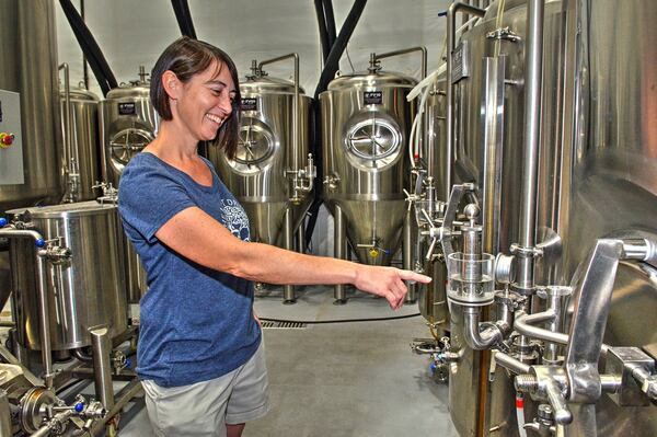 Lost Druid owner Stacia Familo-Hopek gives a brief tour of the brewing facilities, showing one of the fermenting indicators on the side of one of the tanks.