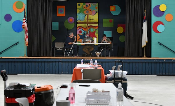 In this file photo, From left, Jim Zvikas, R.N., Riley Erickson, site manager with CORE, and Douglas Ruano, with CORE, eat their lunch as they wait for the last scheduled client showing up at North Springs United Methodist Church in Sandy Springs. (Hyosub Shin / Hyosub.Shin@ajc.com)