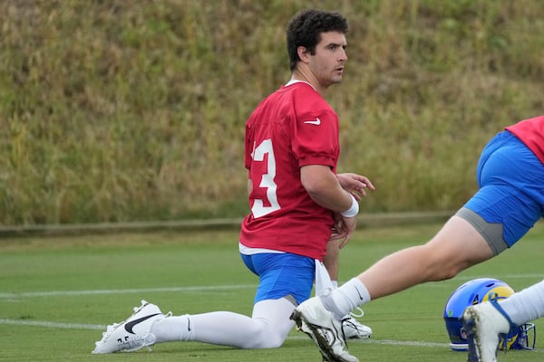 Los Angeles Rams quarterback Stetson Bennett stretches during the NFL football team's organized team activities Tuesday, May 23, 2023, in Thousand Oaks, Calif. (AP Photo/Marcio Jose Sanchez)