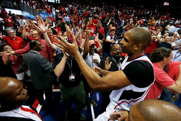 In this May 13, 2015, photo, Atlanta Hawks' Al Horford, right, high-fives fans after the Hawks beat the Washington Wizards 82-81 in Game 5 of the second round of the NBA basketball playoffs in Atlanta. The top-seeded Hawks are hosting LeBron James and the Cleveland Cavaliers on Wednesday, May 20, in Atlantas first Eastern Conference finals. (AP Photo/John Bazemore, File)