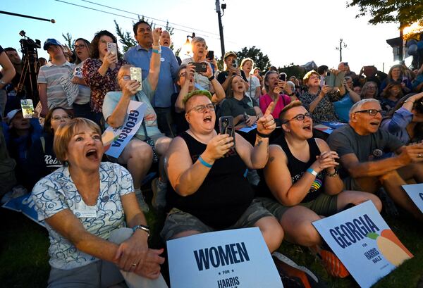 Samantha Cumming (third from left) cheers as actress Julia Roberts speaks during a rally Wednesday in Canton. Cumming said she was planning to attend the event anyway, but the placement of Roberts on the agenda added some luster. “I think she is a citizen, and just like anybody else, she has the right to support anyone,” Cumming said. (Hyosub Shin/AJC)