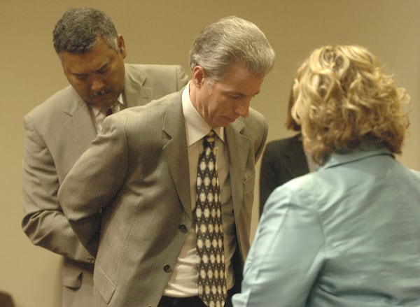 DeKalb County Sheriff Thomas Brown (left) puts handcuffs on Colvin "Butch " Hinton Monday, September 19, 2005, after he was convicted and sentenced to life for the murder of Shannon Melendi. Defense attorney B.J. Bernstein (right)  looks on.