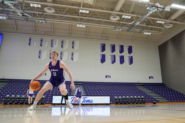 St. Thomas guard Drake Dobbs (11) takes part in drills during NCAA college basketball practice, Wednesday, Feb. 26, 2025, in St. Paul, Minn. (AP Photo/Abbie Parr)