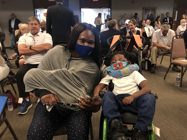 Jessica Reid of Atlanta says the approval of medical marijuana oil licenses will help her legally obtain low THC oil for her 4-year-old son, Emmanuel, who suffers from seizures. Reid attended the meeting of the Georgia Access to Medical Cannabis Commission at the Walker County Civic Center on Saturday, July 24, 2021. MARK NIESSE / MARK.NIESSE@AJC.COM