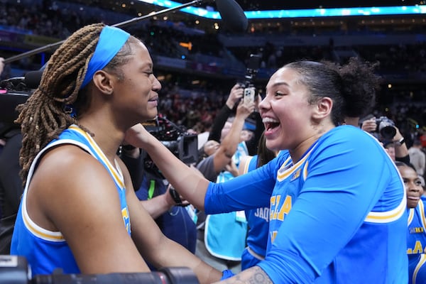 UCLA forward Janiah Barker, left, and Timea Gardiner, right, celebrate after an NCAA college basketball game against Southern California in the championship of the Big Ten Conference tournament in Indianapolis, Sunday, March 9, 2025. (AP Photo/Michael Conroy)