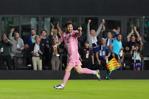 Inter Miami forward Lionel Messi (10) celebrates scoring his side's first goal against Sporting Kansas City during the first half of a CONCACAF Champions Cup soccer match, Tuesday, Feb. 25, 2025, in Fort Lauderdale, Fla. (AP Photo/Rebecca Blackwell)