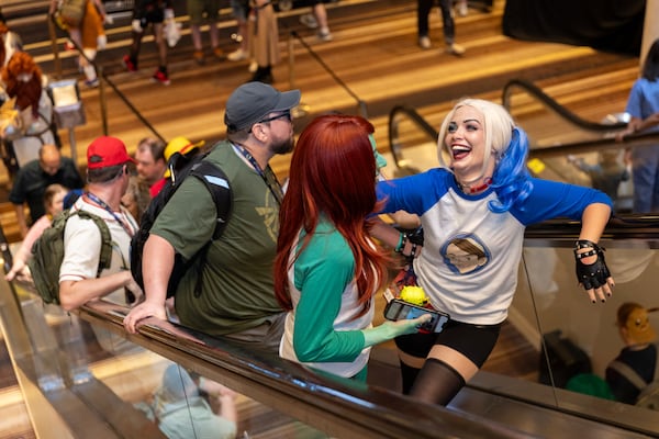 Jessica Vollero, cosplaying as Harley Quinn, laughs with friends at the Marriott during Dragon Con in downtown Atlanta on Friday, August 30, 2024. (Arvin Temkar / AJC)