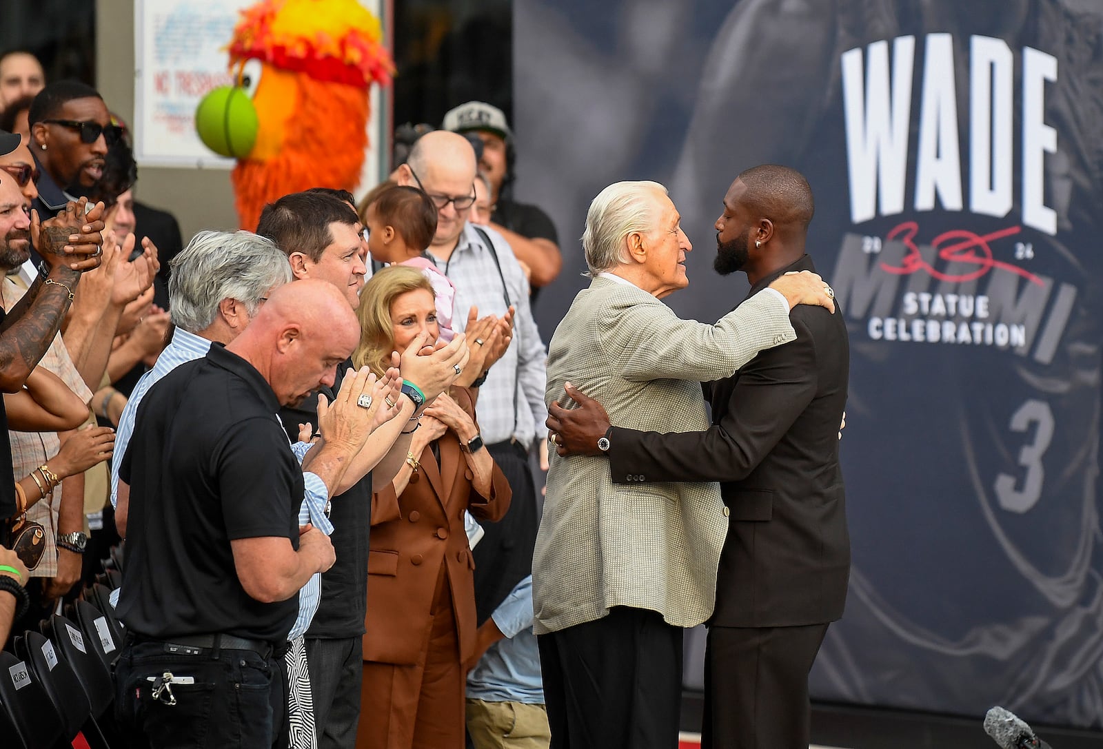 Former Miami Heat NBA basketball player Dwyane Wade, right, hugs Heat president Pat Reiley during a statue unveiling ceremony outside the Kaseya Center, Sunday, Oct. 27, 2024, in Miami, Fla. (AP Photo/Michael Laughlin)