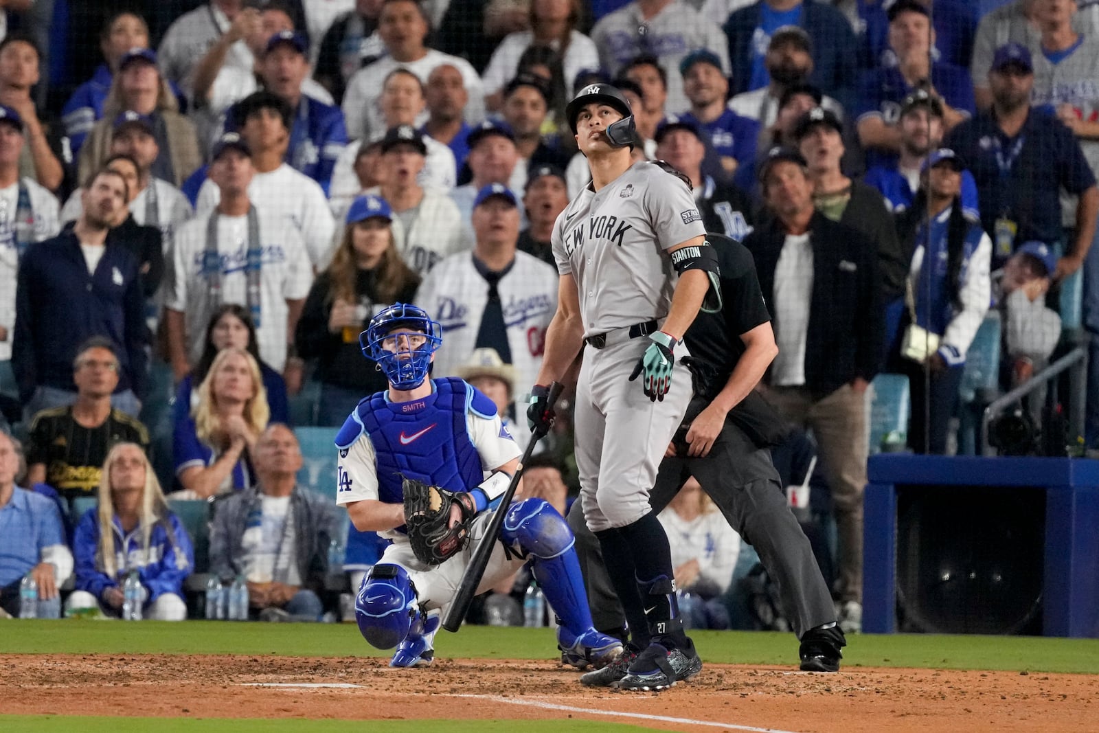 New York Yankees' Giancarlo Stanton watches his two-run home during the sixth inning in Game 1 of the baseball World Series against the Los Angeles Dodgers, Friday, Oct. 25, 2024, in Los Angeles. (AP Photo/Mark J. Terrill)