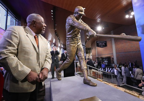  Braves legend Hank Aaron admires his new statue at SunTrust Park. Aaron will throw the ceremonial first pitch Friday. (Curtis Compton/AJC)