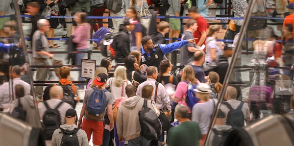 LEDE PHOTO - May 22, 2015 Hartsfield-Jackson International Airport : Security lines were long at Hartsfield-Jackson International Airport on Friday May 22, 2015as the Memorial Day weekend was underway. Airport officials warned travelers to allow extra time to get through the airport during the busy Memorial Day weekend. The Transportation Security Administration may have a record-breaking day at Hartsfield-Jackson International Airport on Friday with more than 76,000 travelers going through security checkpoints, said TSA spokesman Mark Howell. "We are urging passengers to arrive at the airport at least two hours before the scheduled departure time, and to add additional time if parking at the airport," since many airport parking areas will be filling up, Howell said. Travelers should also allow extra time for traffic, he added. For international passengers, Hartsfield-Jackson advised arriving at the airport three hours in advance. Including departing, arriving and connecting passengers, Hartsfield-Jackson expects a total of 1.8 million travelers over the Memorial Day travel period. JOHN SPINK / JSPINK@AJC.COM