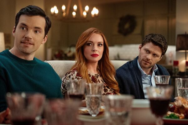 This image released by Netflix shows Ian Harding, from left, Lindsay Lohan and Jon Rudnitsky in a scene from "Our Little Secret." (Bob Mahoney/Netflix via AP)