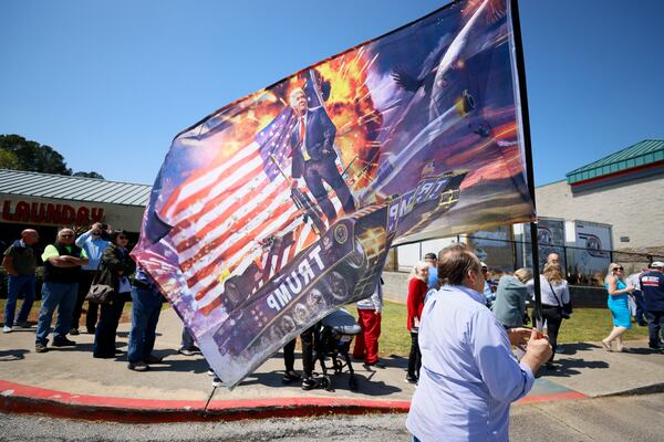 Supporters of former President Donald Trump rallied Thursday in the parking lot of the Adventures Outdoors gun store in Smyrna while his potential rival for the GOP presidential nomination in 2024, Florida Gov. Ron DeSantis, spoke inside. Miguel Martinez / miguel.martinezjimenez@ajc.com