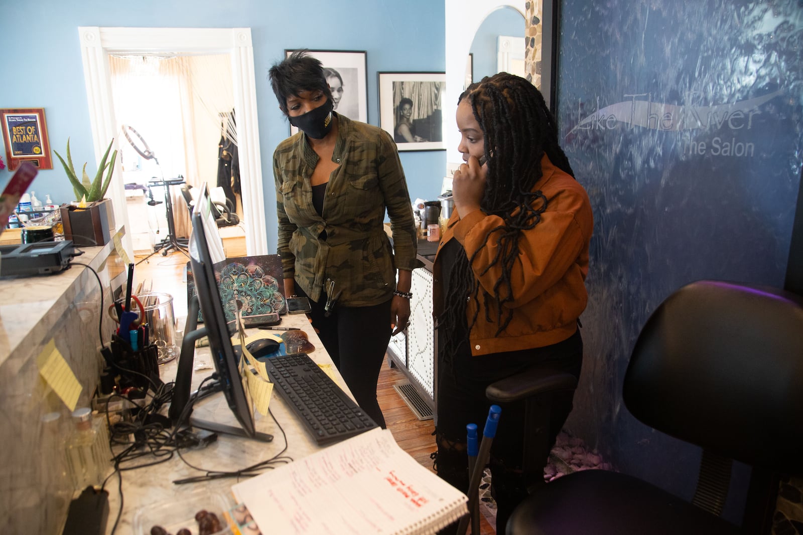 Like the River Salon owner Najah Aziz, ,left, and Leah Dixon set up a Zoom call with a client at the salon in Atlanta last week. During the quarantine, Aziz went live on Instagram showing clients how to wash and style their hair at home. She also started doing video consultations to answer their questions. (STEVE SCHAEFER FOR THE ATLANTA JOURNAL-CONSTITUTION)