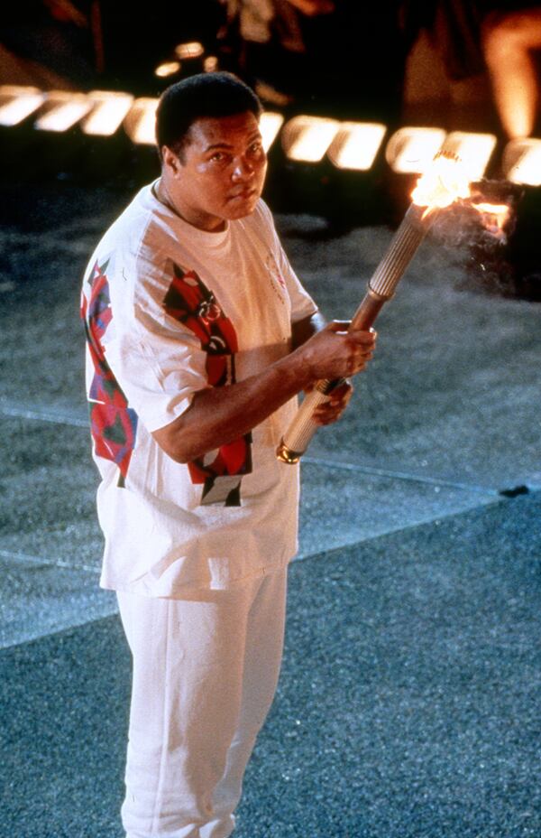 Muhammad Ali watches the wick that is about to ignite the Olympic Caldron during the Opening Ceremonies for the 1996 Summer Olympic Games Friday, July 19, 1996 at the Olympic Stadium in Atlanta.  (Allen Eyestone/AJC)