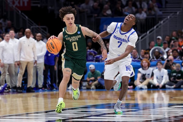 Colorado State guard Kyan Evans, left, drives past Memphis guard PJ Carter during the second half in the first round of the NCAA college basketball tournament, Friday, March 21, 2025, in Seattle. (AP Photo/Ryan Sun)