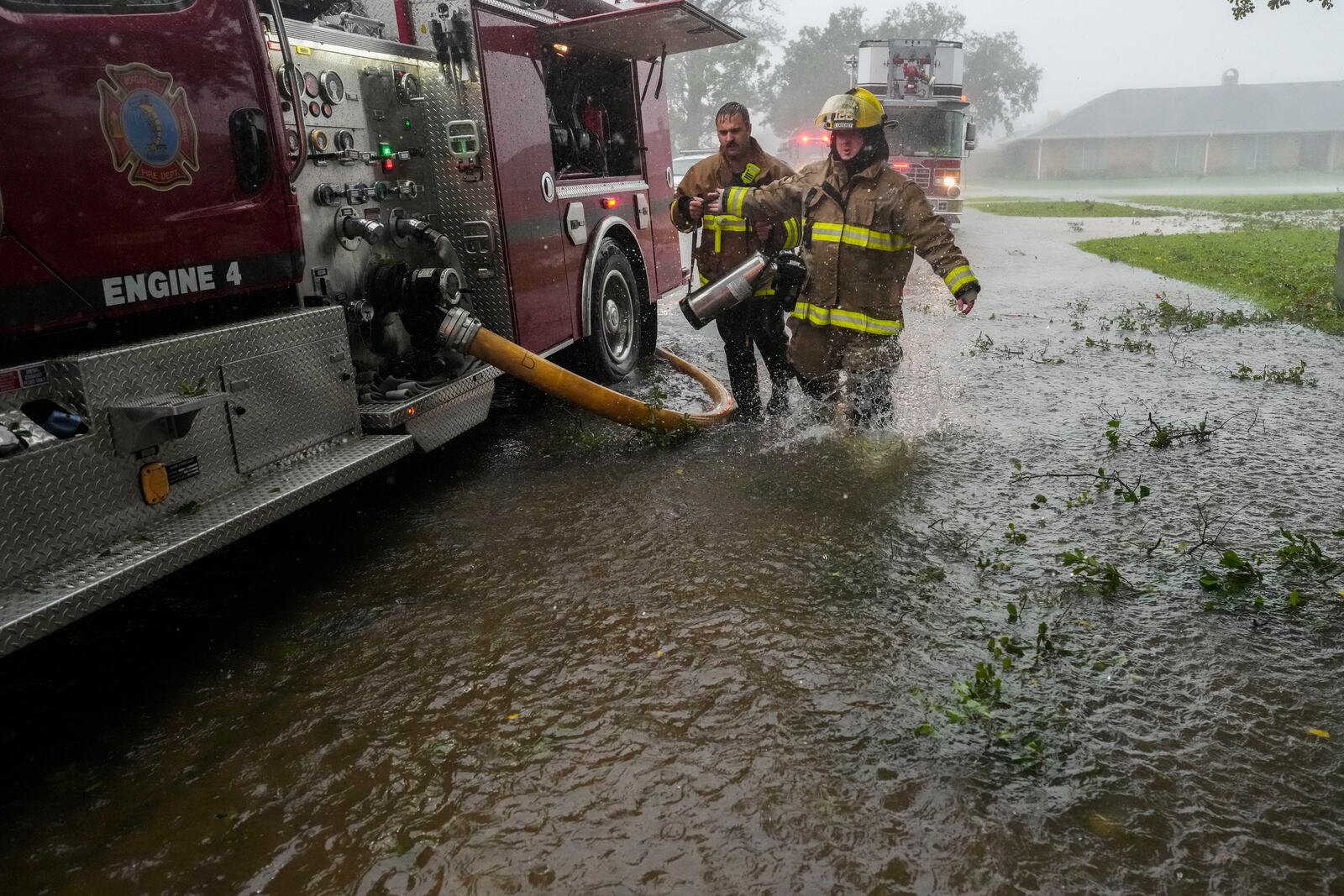 Morgan City firefighters respond to a home fire during Hurricane Francine in Morgan City, La., Wednesday, Sept. 11, 2024. (AP Photo/Gerald Herbert)