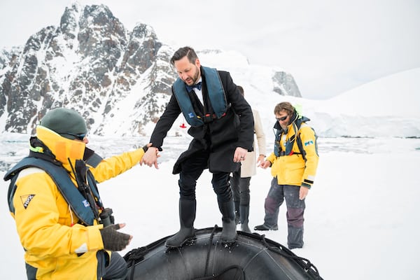 Hollis Smith boards a Zodiac boat that whisked the couple to an ice floe in Antarctica, where he was married to Brian Patrick Flynn. CONTRIBUTED BY ROBERT PETERSON / RUSTIC WHITE PHOTOGRAPHY