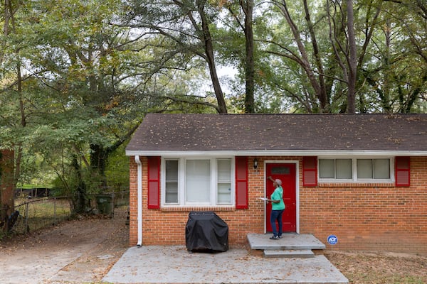 Canvasser Linda McIntosh knocks on a door to promote the city’s WeatheRISE weatherization program in Atlanta Friday, October 27, 2023. (Arvin Temkar / arvin.temkar@ajc.com)