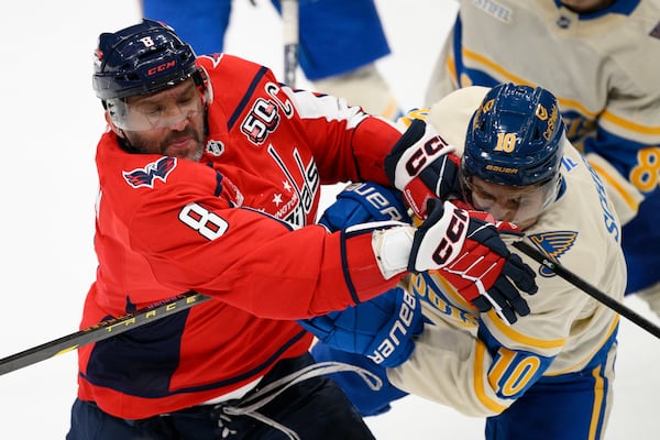 Washington Capitals left wing Alex Ovechkin (8) and St. Louis Blues center Brayden Schenn (10) collide during the third period of an NHL hockey game, Thursday, Feb. 27, 2025, in Washington. (AP Photo/Nick Wass)