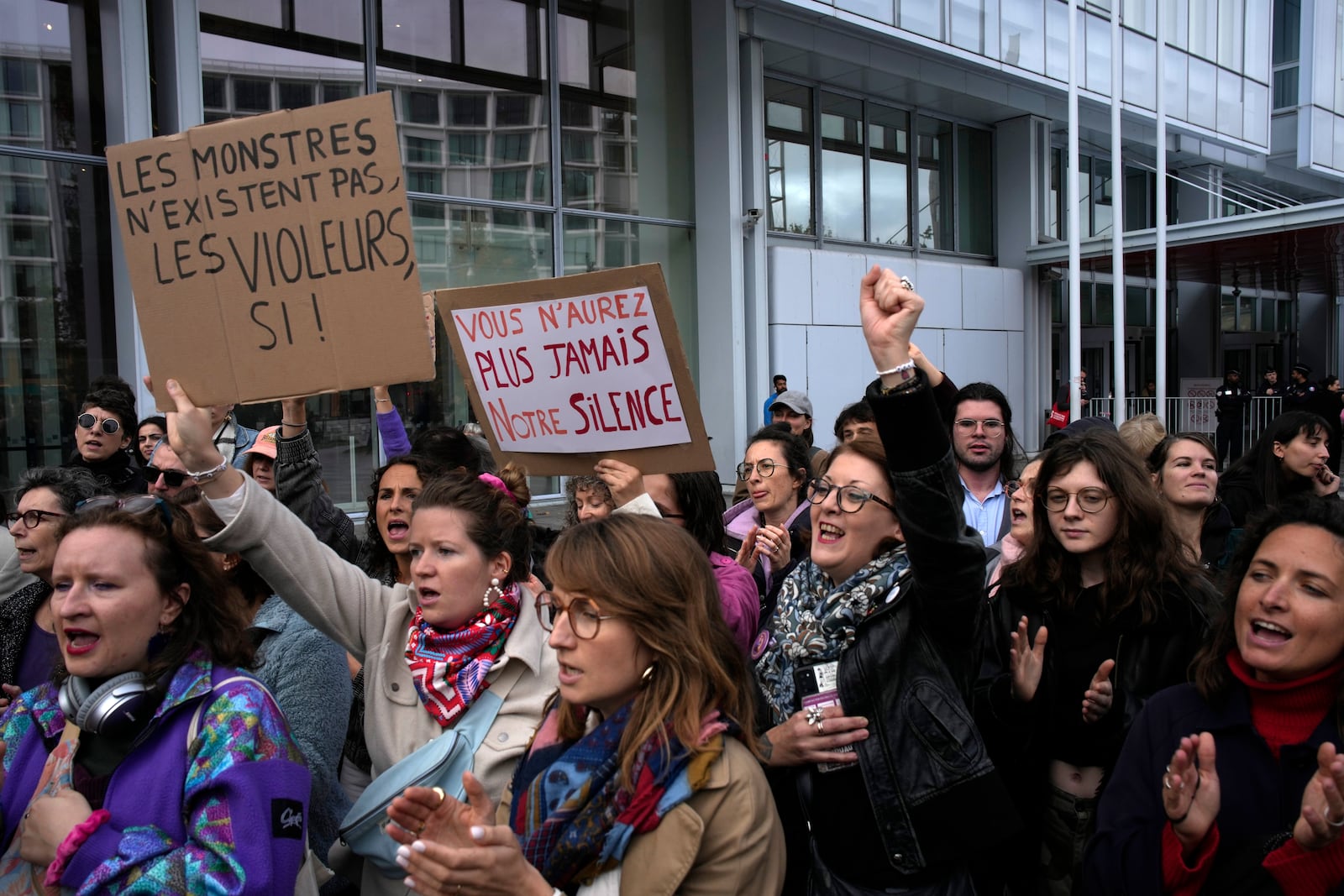 Women's rights activists demonstrate outside the Paris palace of justice as French actor Gérard Depardieu, who is facing trial for the alleged sexual assaults of two women on a film set in 2021, won't appear before a criminal court, Monday, Oct. 28, 2024 in Paris. (AP Photo/Louise Delmotte)