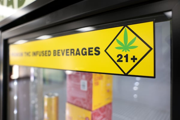 The warning label is shown on a refrigerator with THC-infushed drinks at the Georgia Hemp Company, Tuesday, March, 11, 2025, in Sandy Springs, Ga. The THC-infused drinks that Georgia Hemp Company sells could be banned under a bill pending in the Georgia General Assembly. (Jason Getz / AJC)